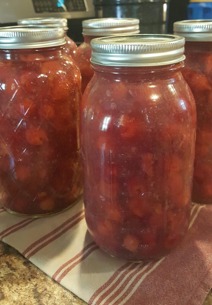 processed jars of beautiful red cherry pie filling