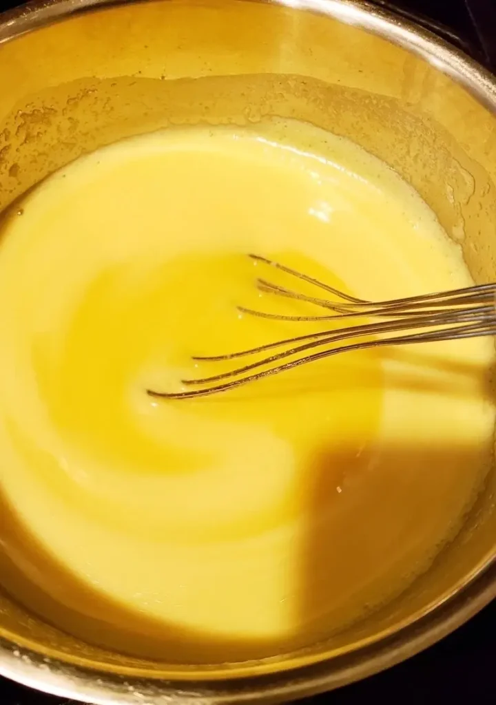 Homemade cooked dressing for potato salad made with eggs, vinegar, mustard, milk, and mayo