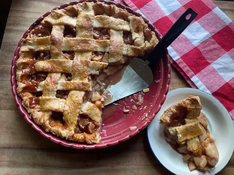 caramel apple pie on a white plate