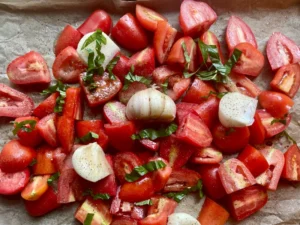 Easy Creamy Roasted Tomato Soup made with fresh garden tomatoes, onion, and garlic. A cozy, comforting soup perfect for summer harvest or chilly fall nights. Pin this recipe for delicious homemade soup to warm up with!