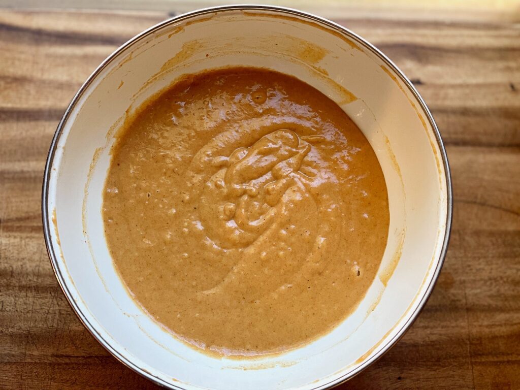 combined wet and dry ingredients for baked pumpkin donuts with streusel and maple glaze drizzle
