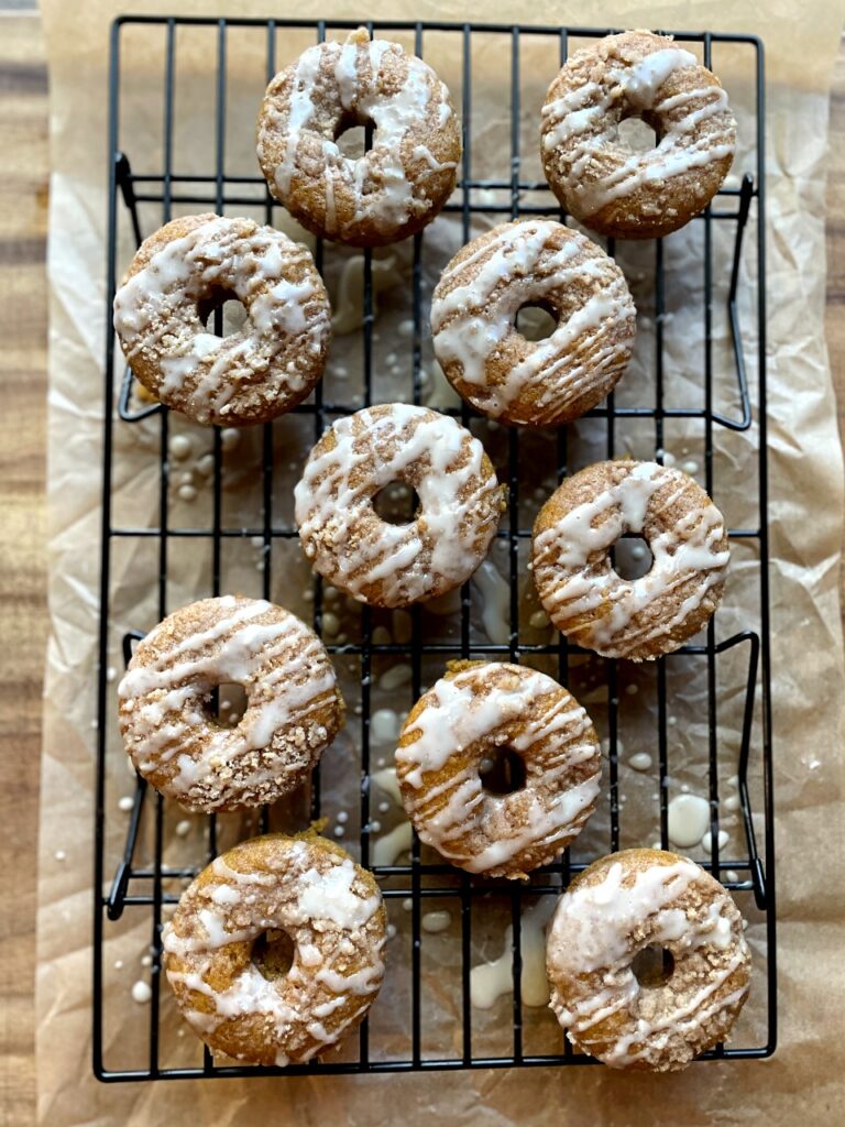 baked pumpkin donuts with streusel and maple glaze drizzle