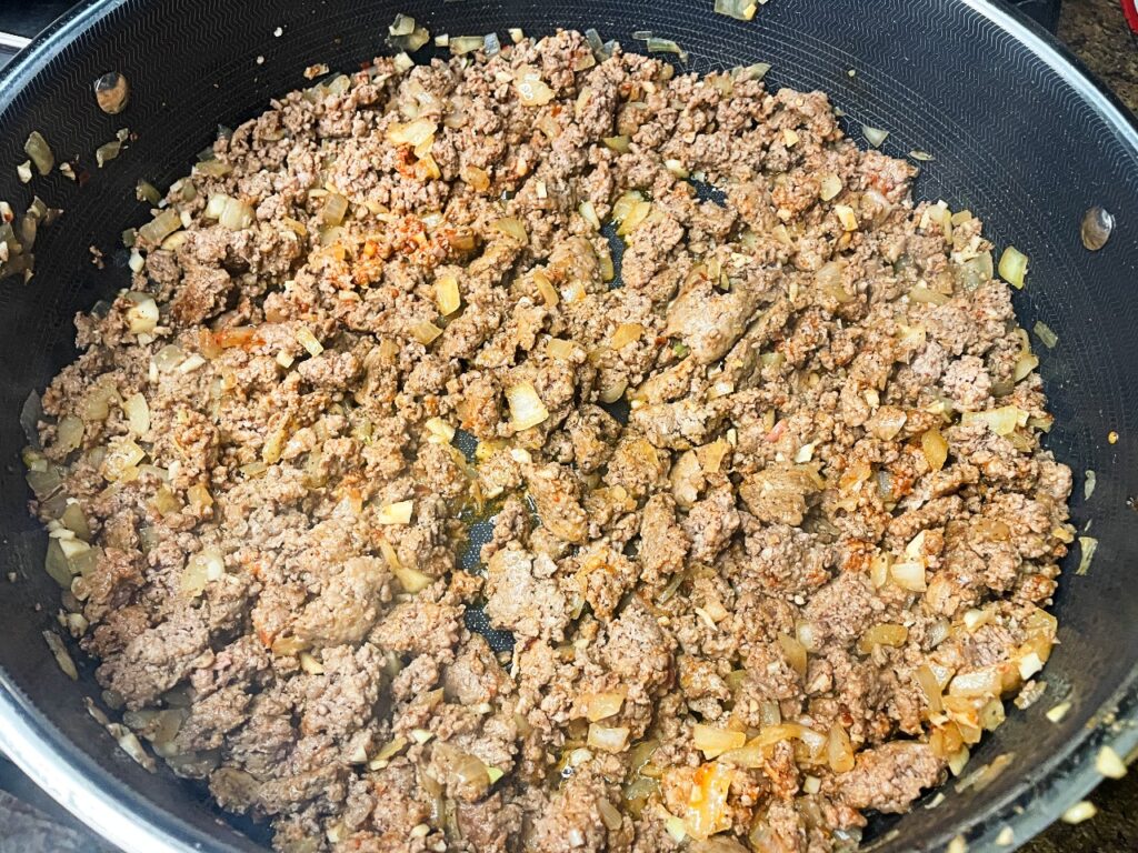 browned ground beef with onions, garlic and tomato paste for Creamy Beef and Cheddar Pasta (One Pan Meal)