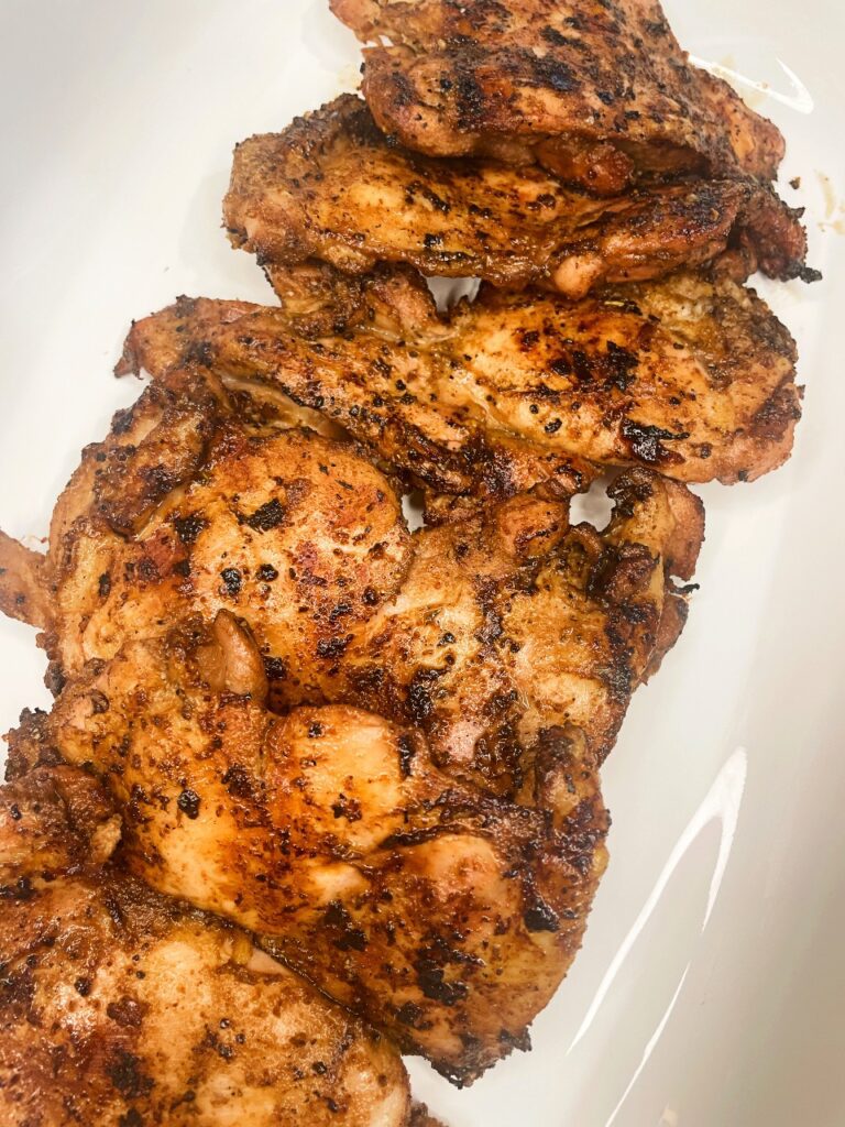 grilled boneless skinless chicken thighs on a platter