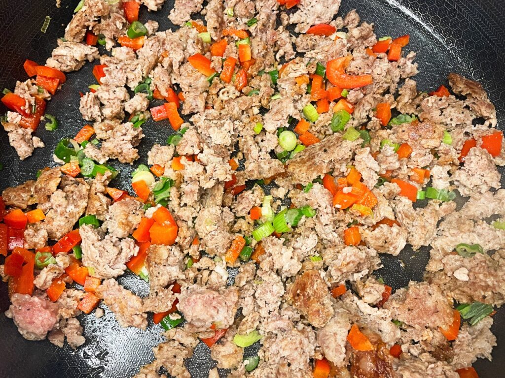 Cooked sausage with peppers and onions