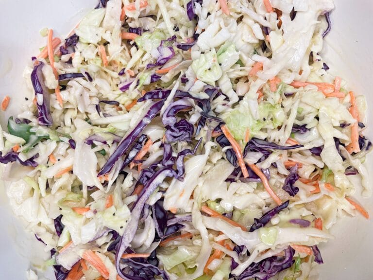 Old-fashioned creamy coleslaw in a white serving bowl