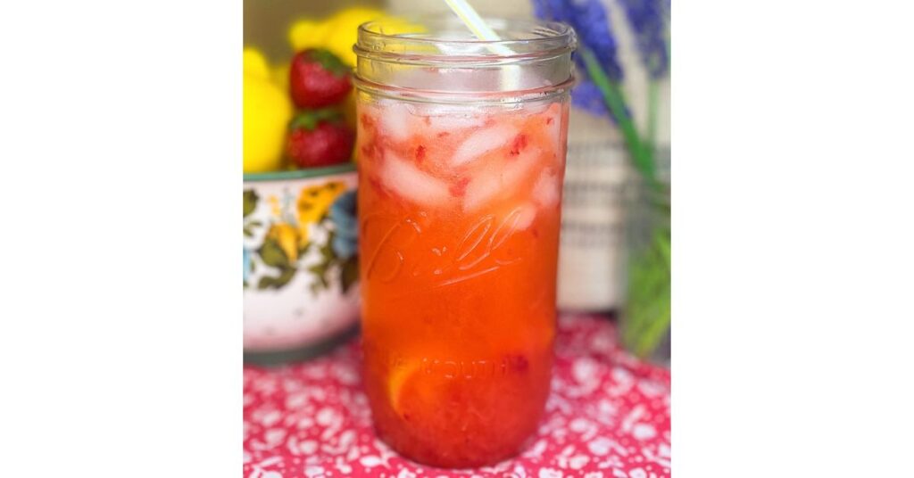 mason jar with ice and strawberry lemonade