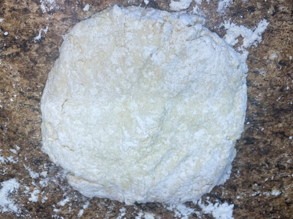 biscuit dough flatten out and folded over itself to create flaky layers 