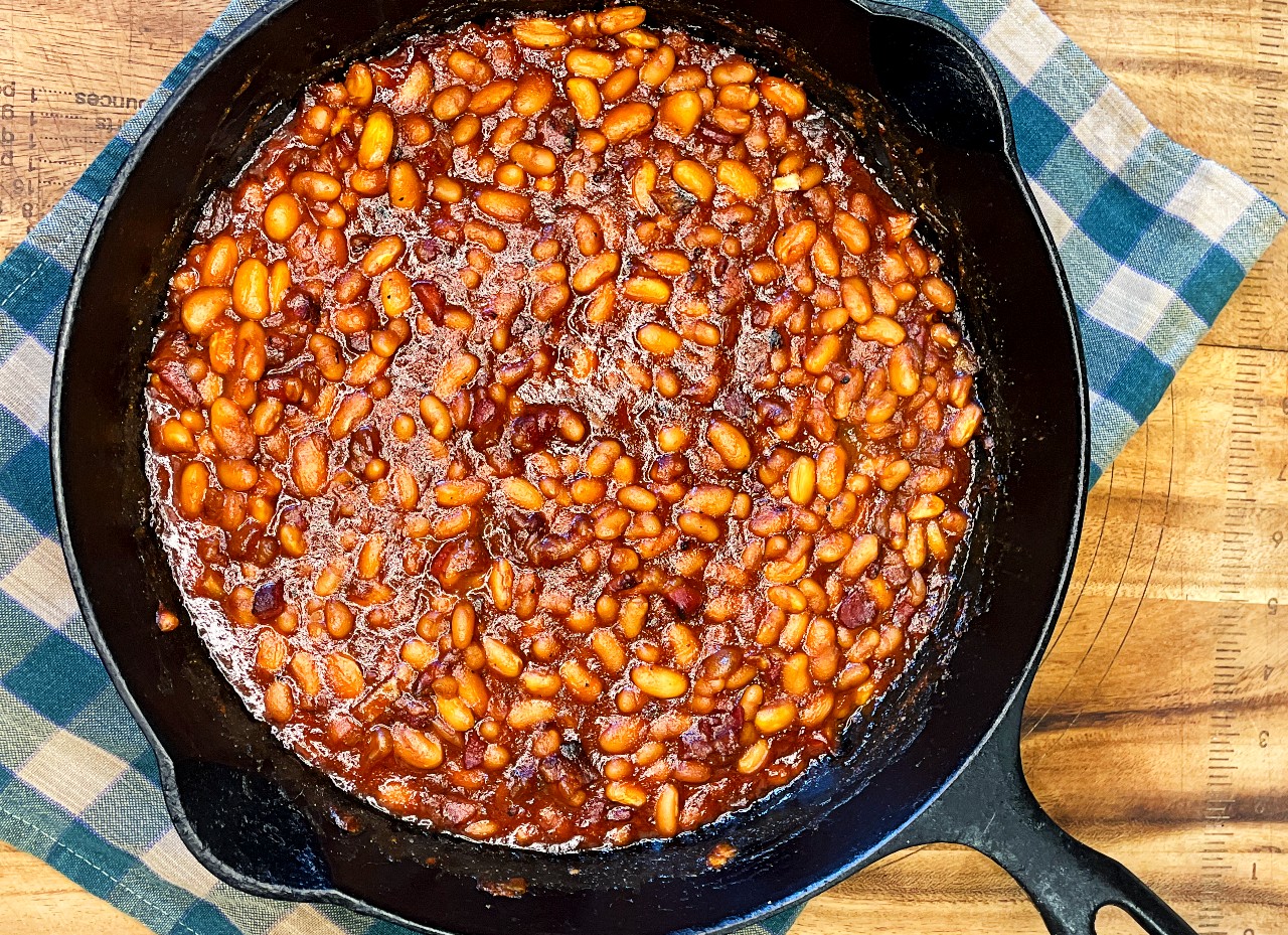 Homemade baked beans with bacon in a baking dish