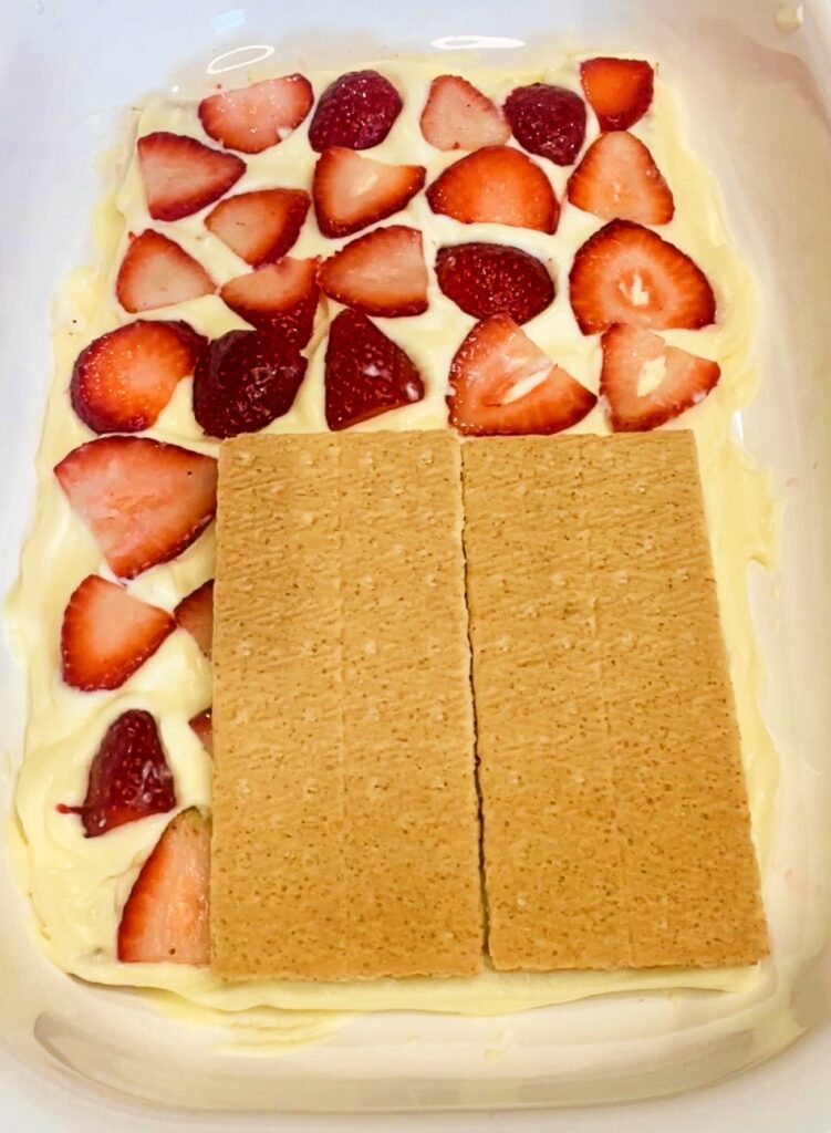 assembling the layers of the strawberry icebox cake