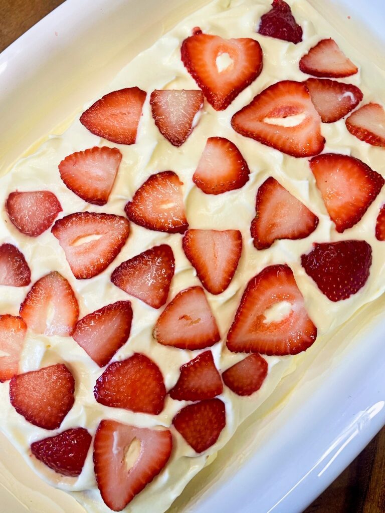 assembling the layers of the strawberry icebox cake