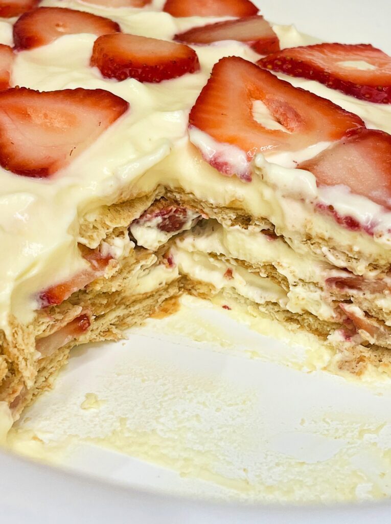 Strawberry icebox cake showing soft graham cracker layers and creamy vanilla filling.