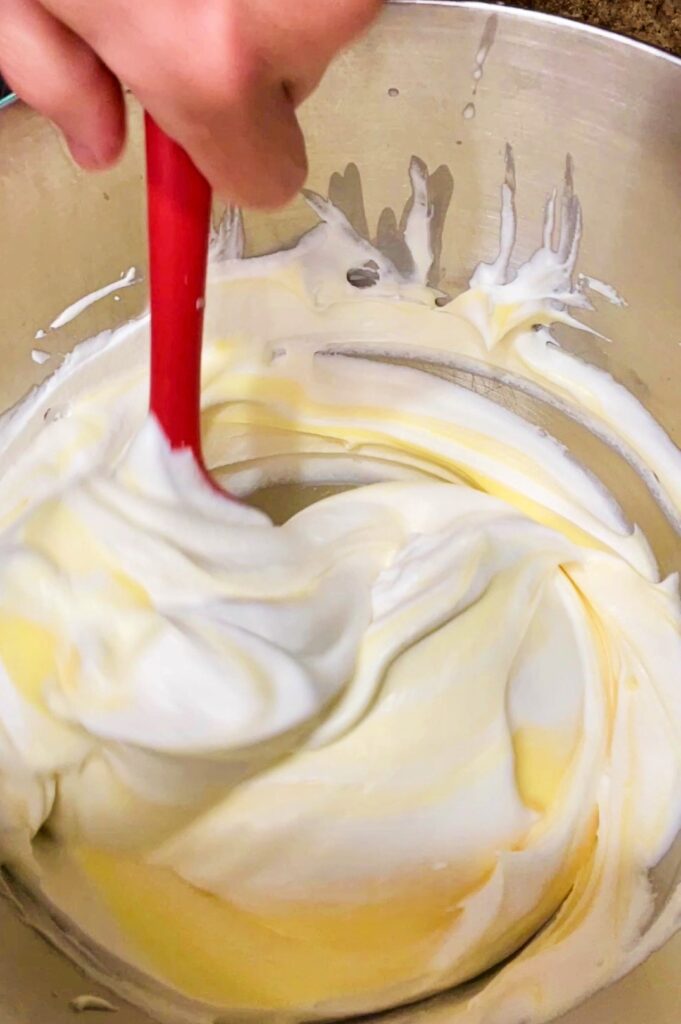 whipped cream being folded into vanilla pudding