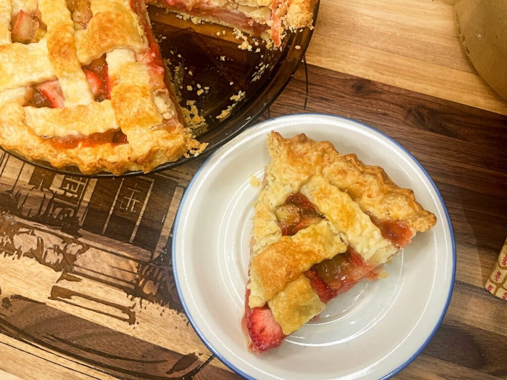 Strawberry Rhubarb pie slice on a serving plate