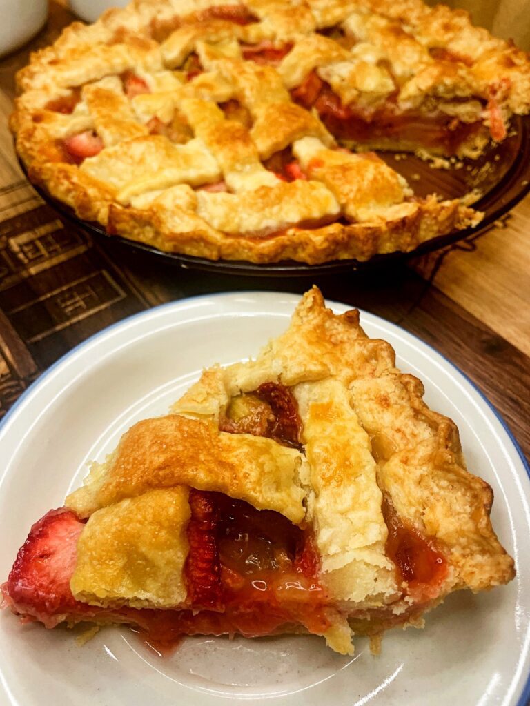 Strawberry Rhubarb pie slice on a serving plate