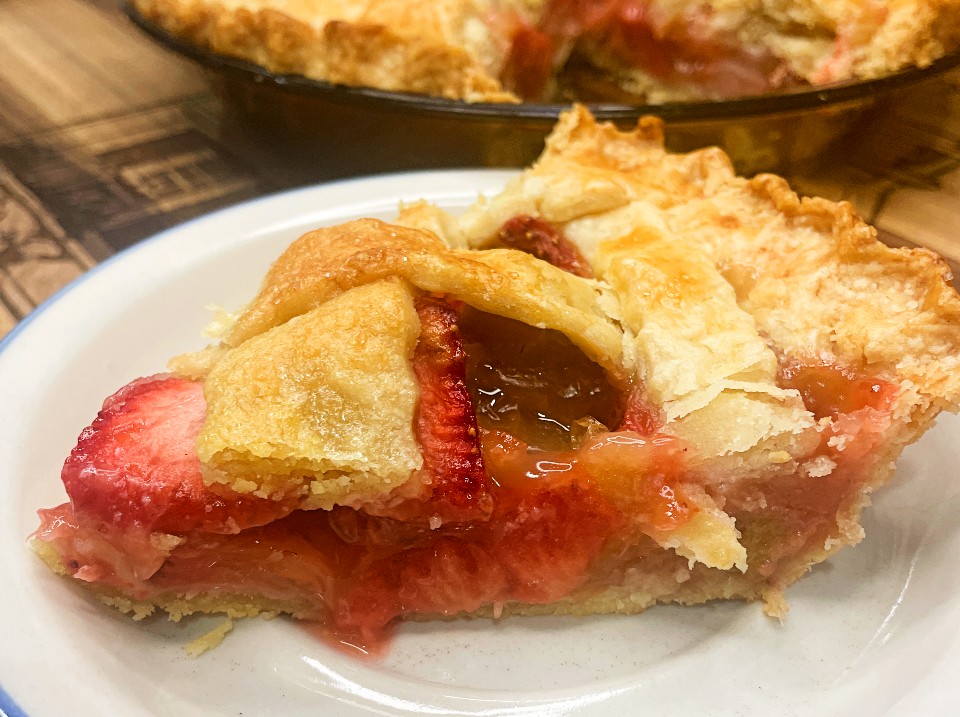 Strawberry Rhubarb pie slice on a serving plate