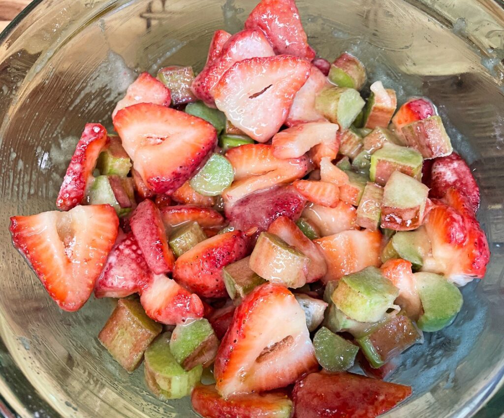 strawberries and rhubarb coated in brown sugar, granulated sugar, cornstarch, vanilla, and orange juice.