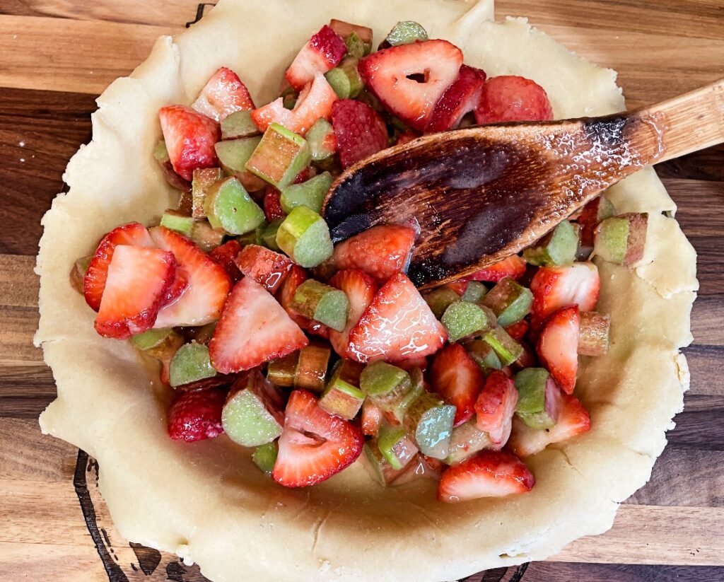 strawberry rhubarb filling placed into a the pie plate