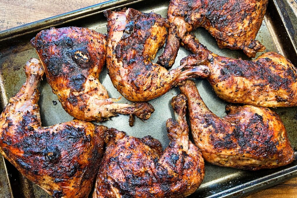 roadside chicken BBQ quarters on a baking sheet