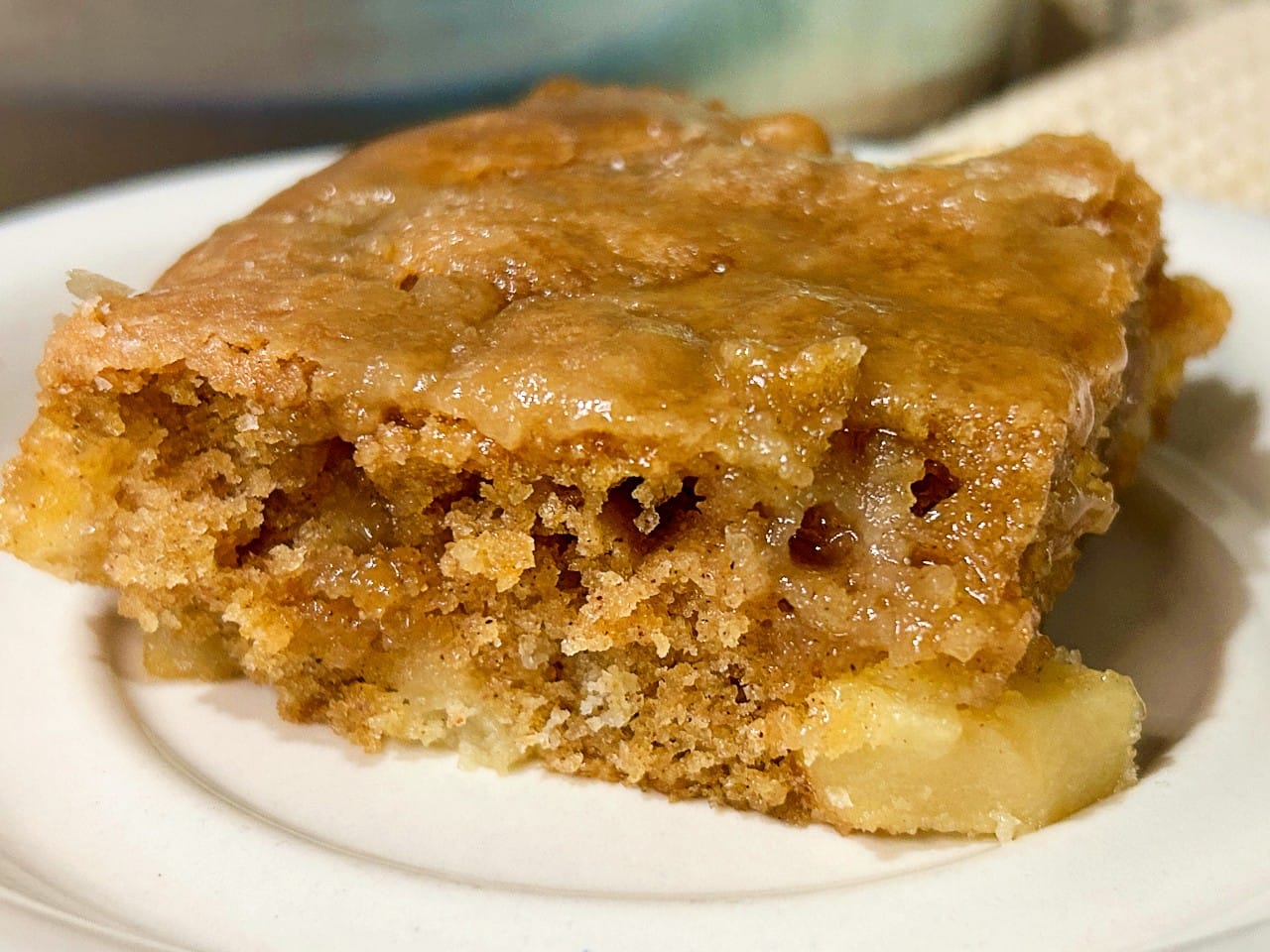 Slice of Old-Fashioned Apple Dapple Cake on a white dessert plate