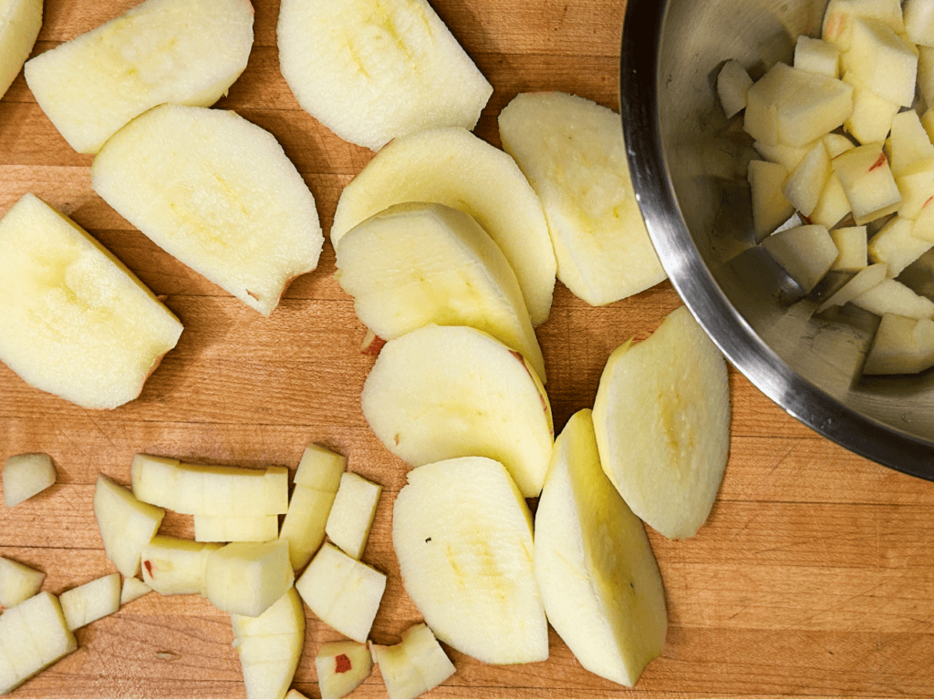 apples being chopped on a cutting board