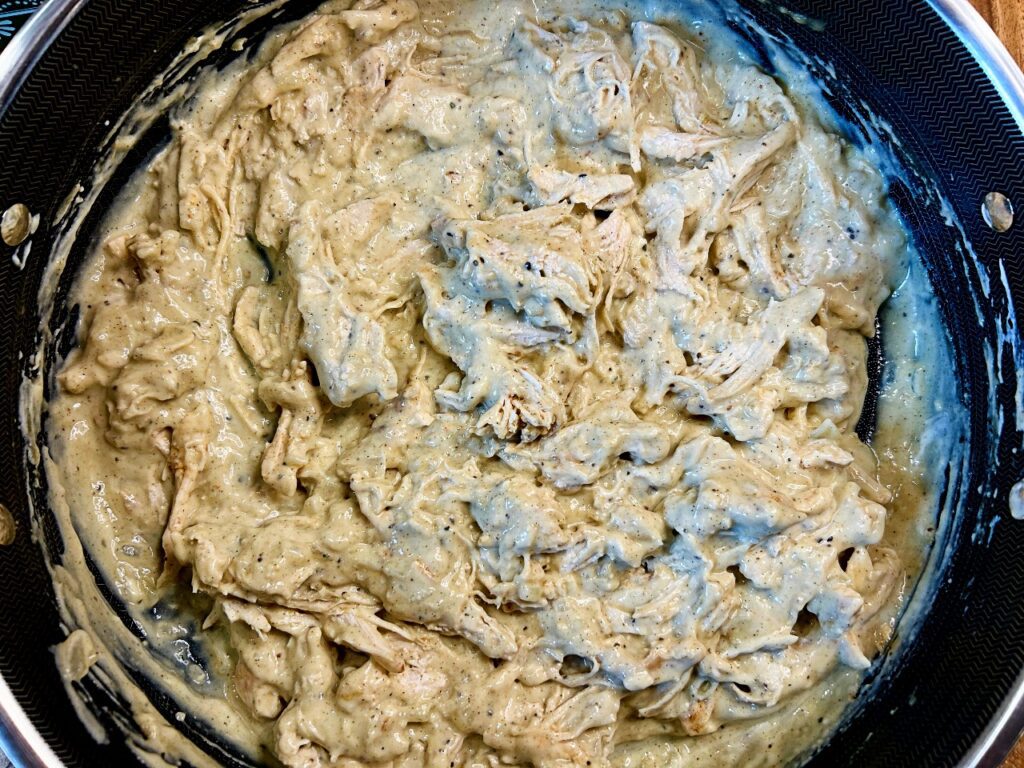 Shredded chicken stirred into creamy herb sauce