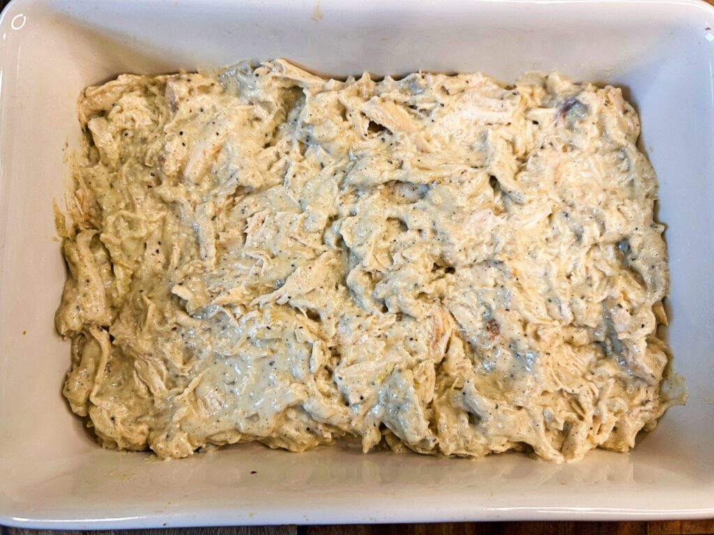 Chicken filling spread into a 9x13 baking dish