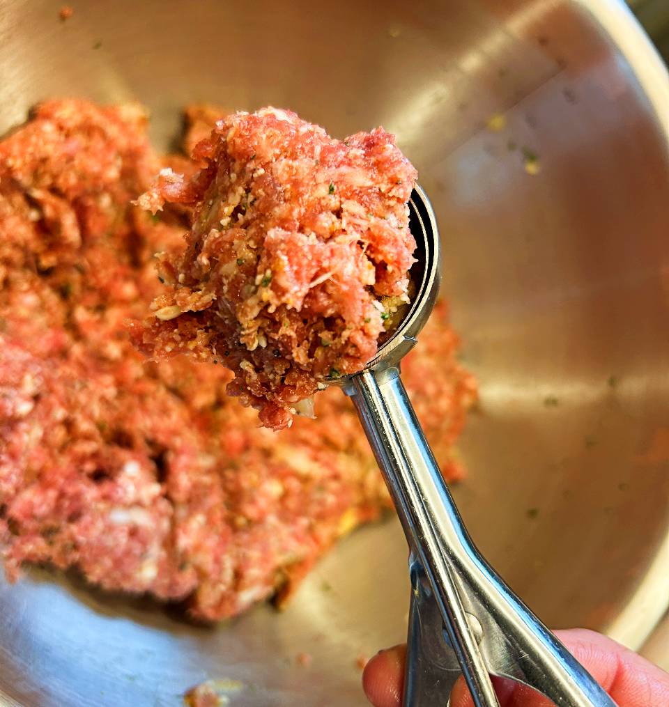 meatball mixture scooped with a cookie scoop to form balls