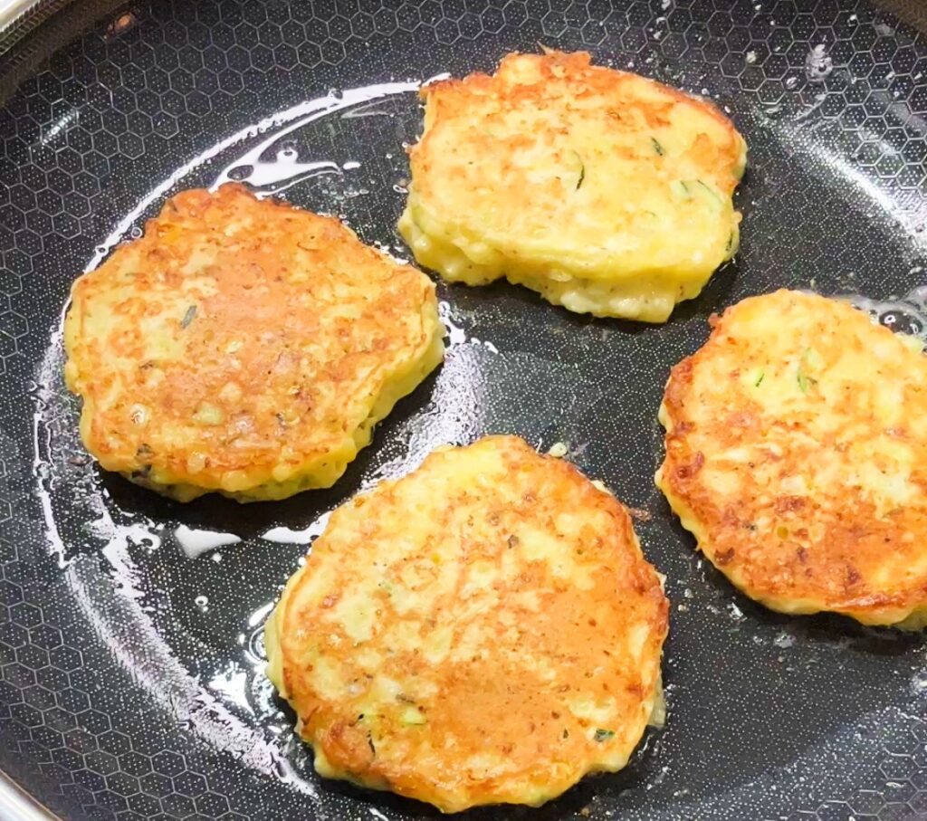 old-fashioned zucchini Fritters frying in the skillet