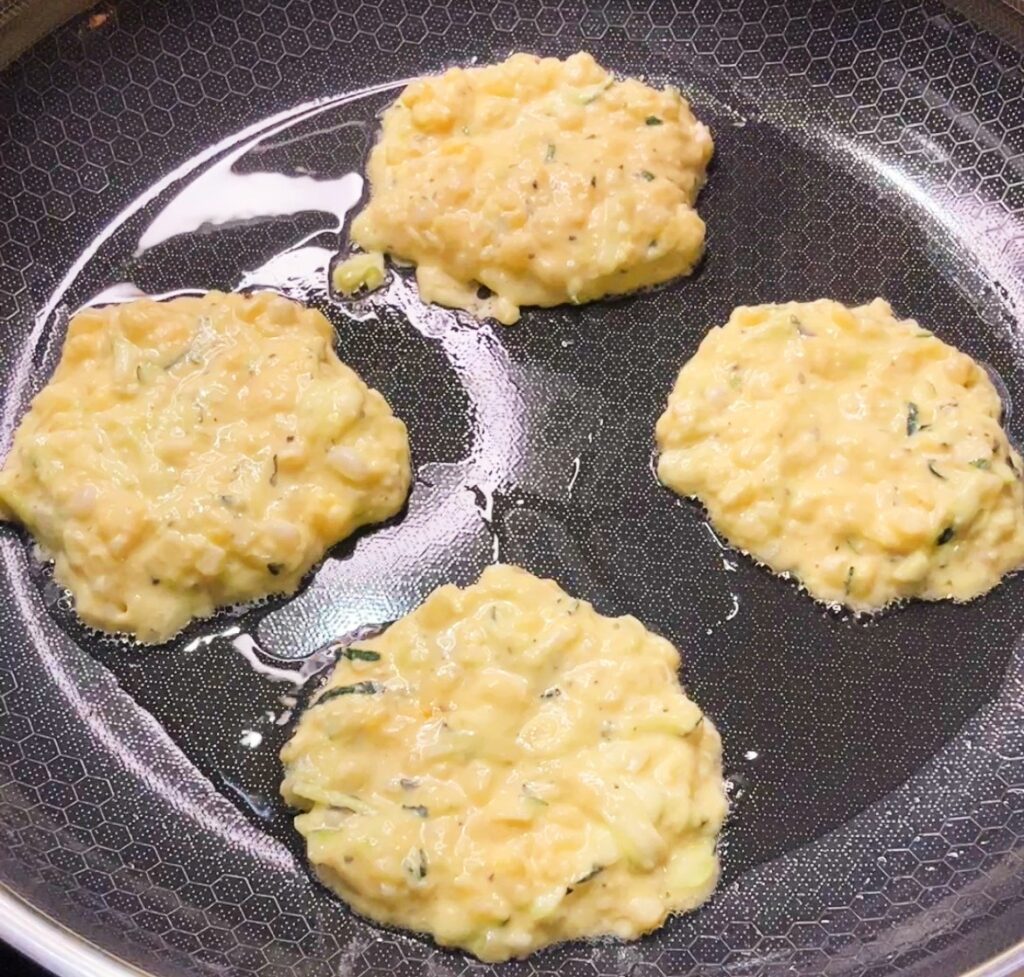 old-fashioned zucchini Fritters frying in the skillet