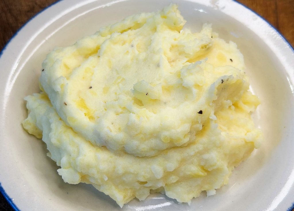 Creamy homemade mashed potatoes made with white and Yukon Gold potatoes topped with butter