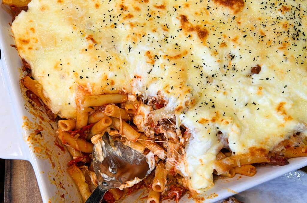 Easy baked ziti with ricotta and mozzarella cheese in a baking dish