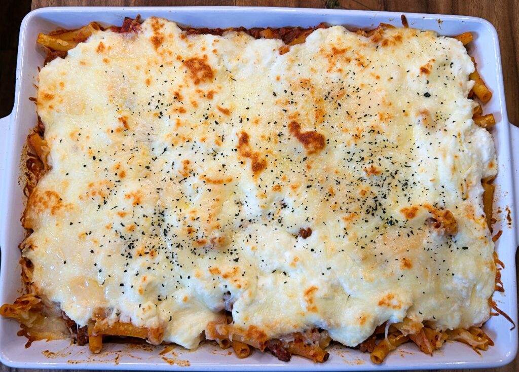Easy baked ziti with ricotta and mozzarella cheese in a baking dish