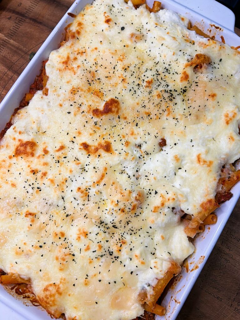 Easy baked ziti with ricotta and mozzarella cheese in a baking dish