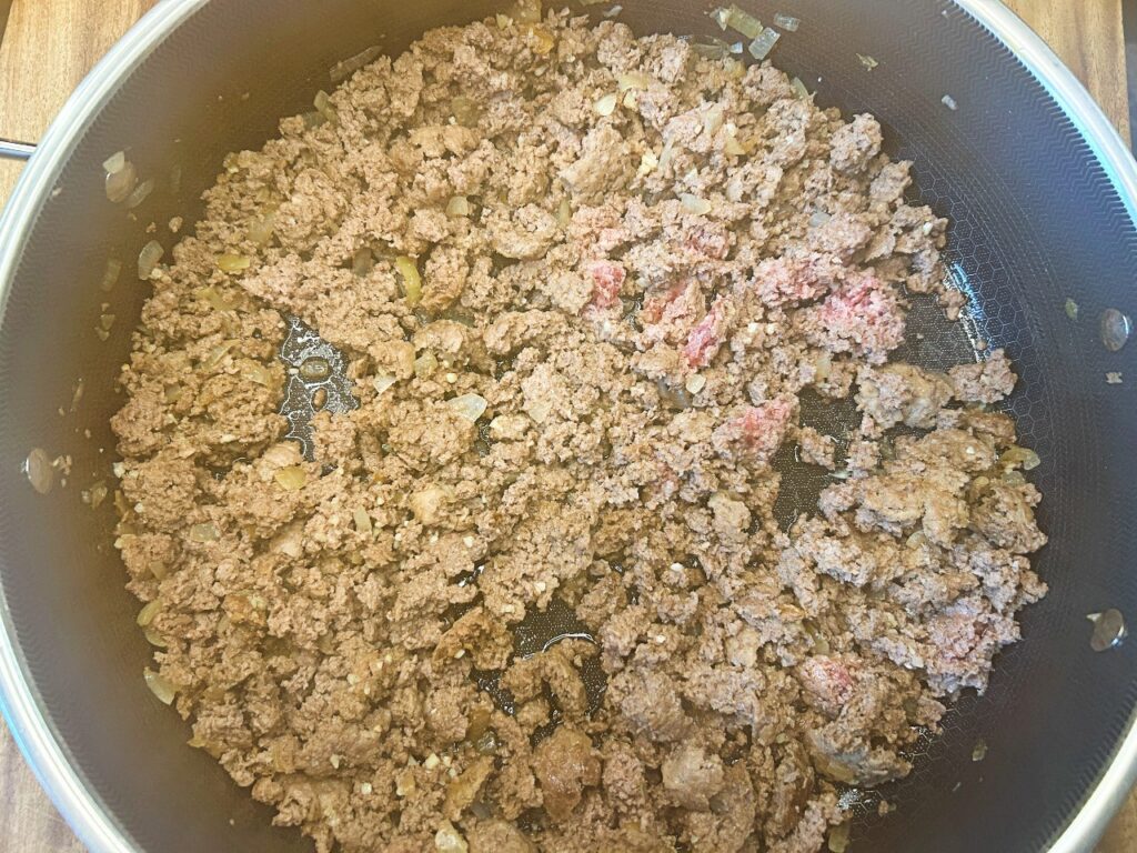 ground beef browning in a skillet