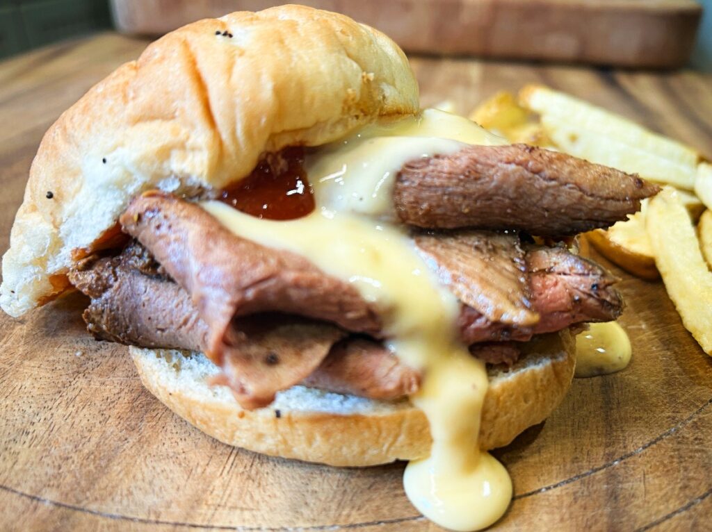 Homemade Beef and Cheddar sandwich with sliced roast beef, cheddar cheese sauce