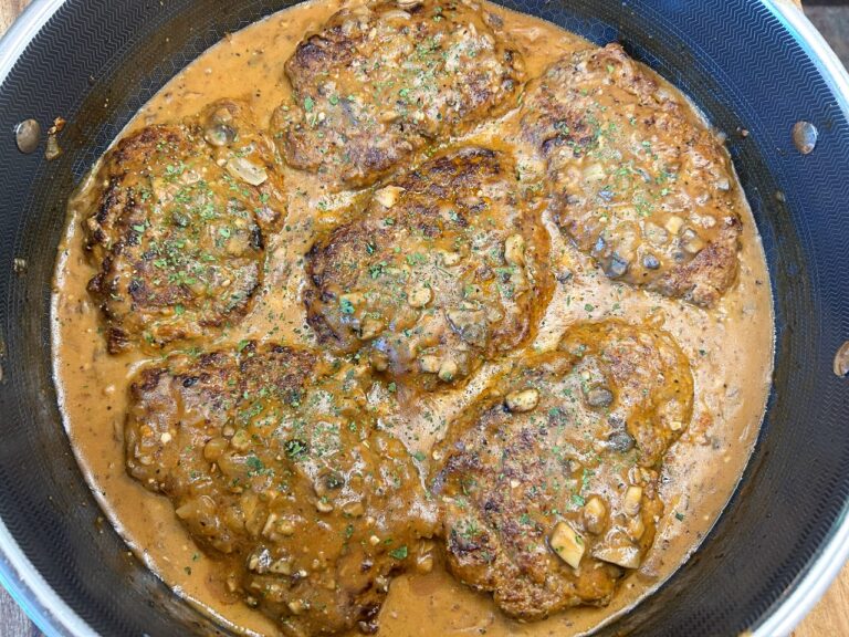 Homemade Salisbury steak with mushroom gravy in a skillet