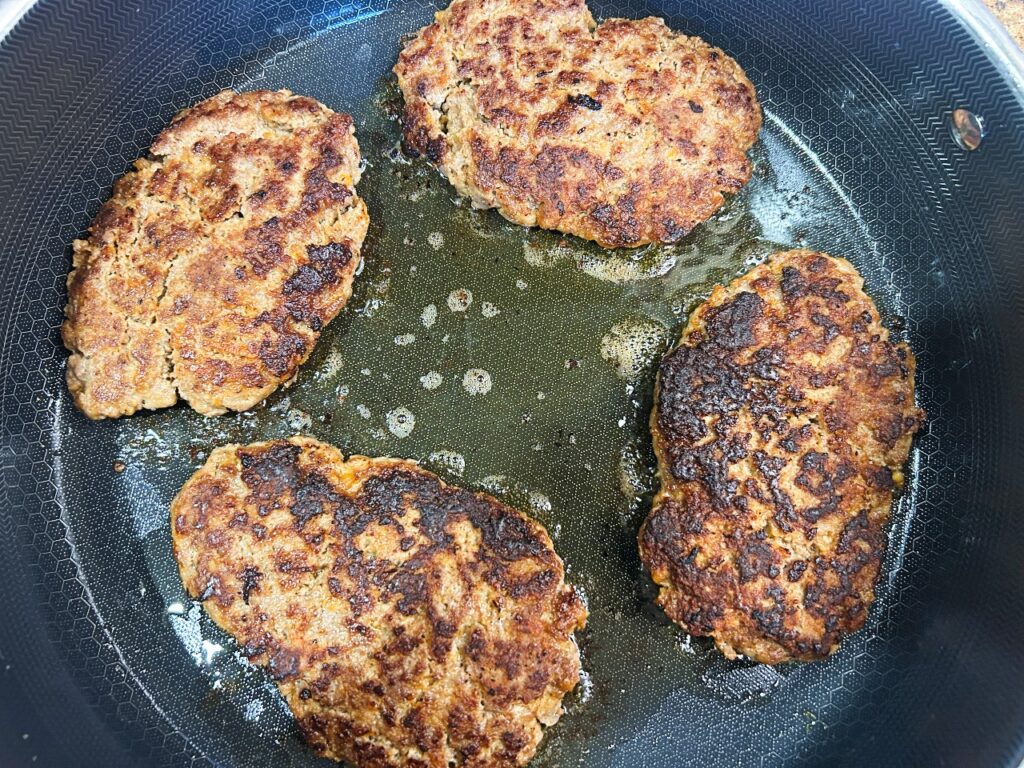 Salisbury steak browning in skillet
