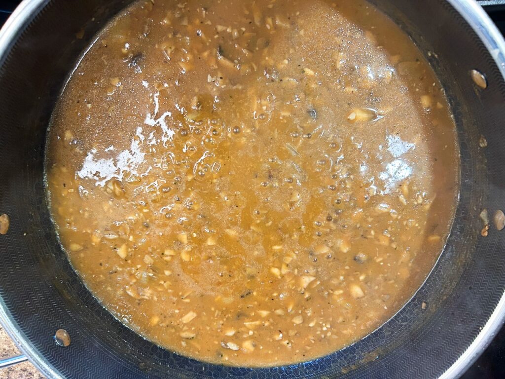 Salisbury steak gravy simmering in skillet