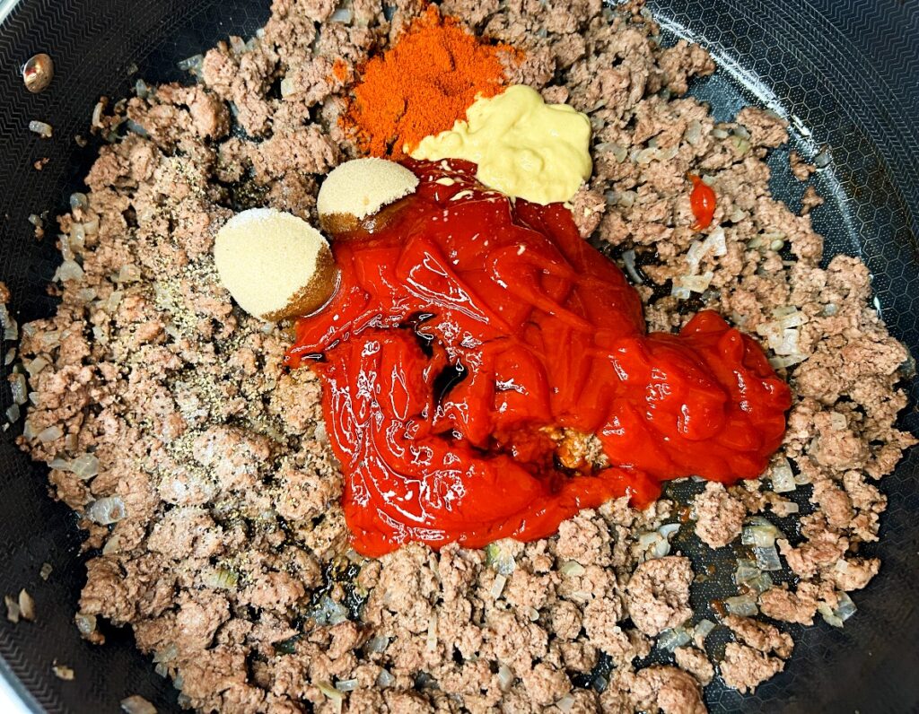 homemade sloppy Joe sauce ingredients in skillet with ground beef and onions