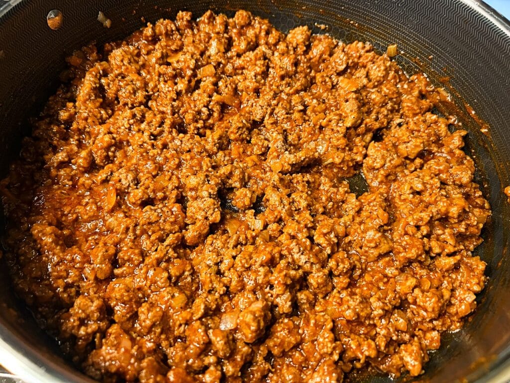 homemade sloppy joe mixture simmering in a skillet.
