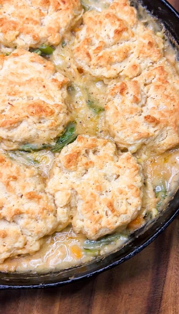 Homemade chicken pot pie with carrots, potatoes, corn and golden biscuits.