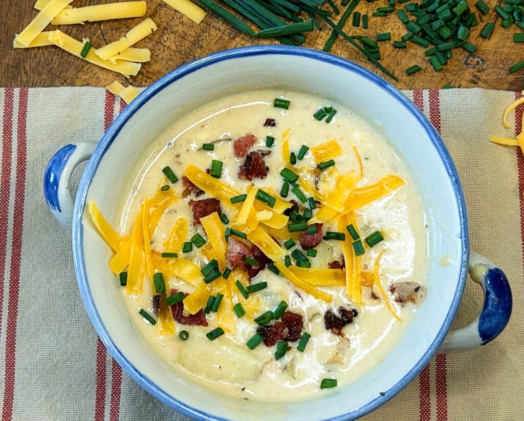 Homemade loaded potato soup made with tender homegrown potatoes, bacon, cheddar cheese, and fresh chives