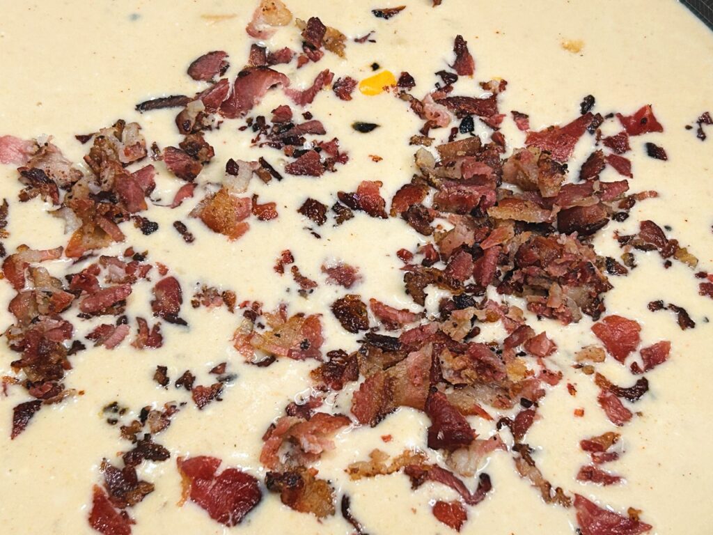 Freshly shredded cheddar cheese melting into creamy potato soup