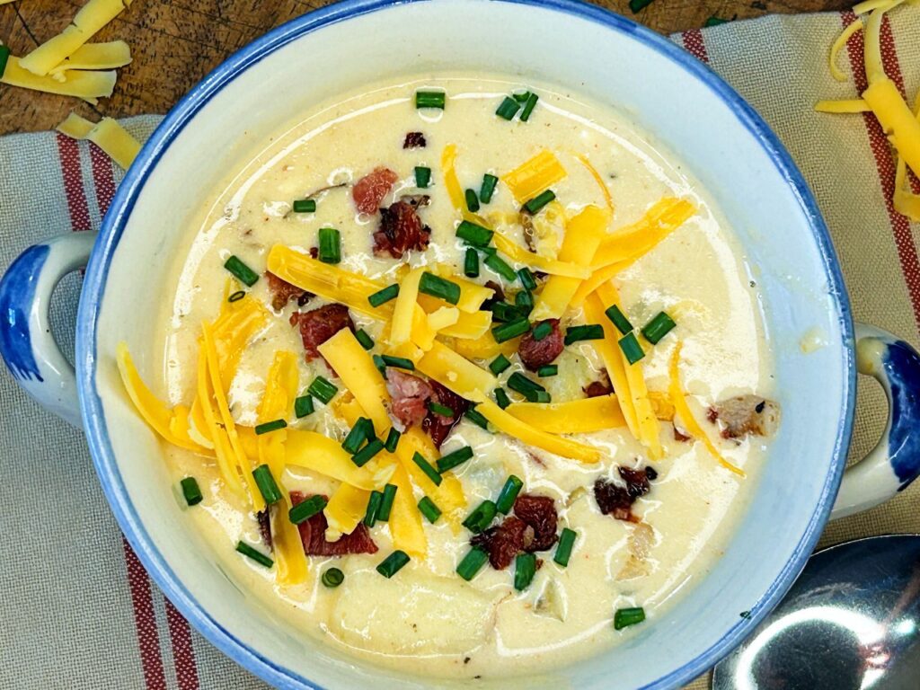 Homemade loaded potato soup made with tender homegrown potatoes, bacon, cheddar cheese, and fresh chives