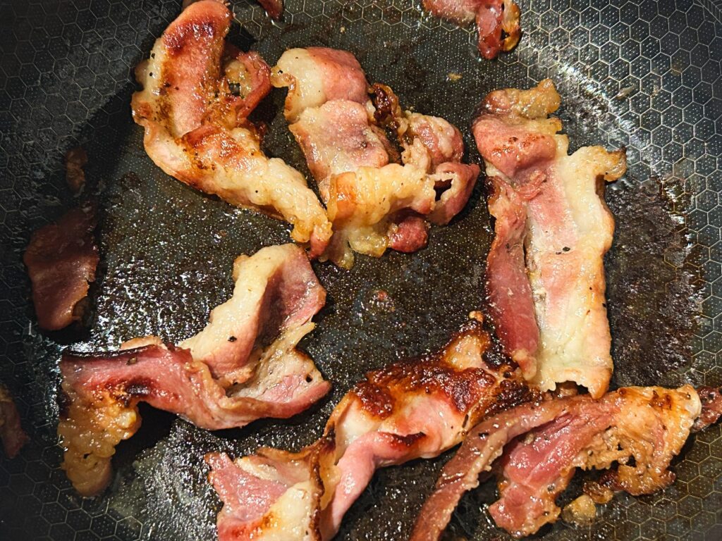Bacon cooking in a Dutch oven for loaded potato soup