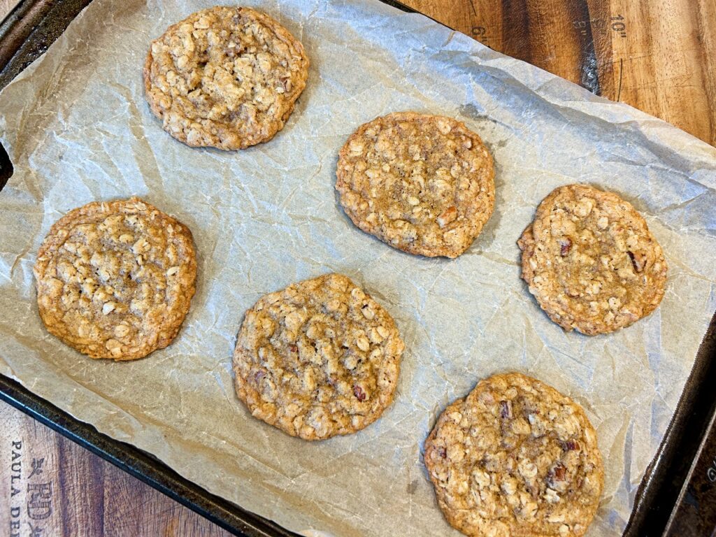 Freshly baked maple pecan oatmeal cookies with golden edges and chewy centers.